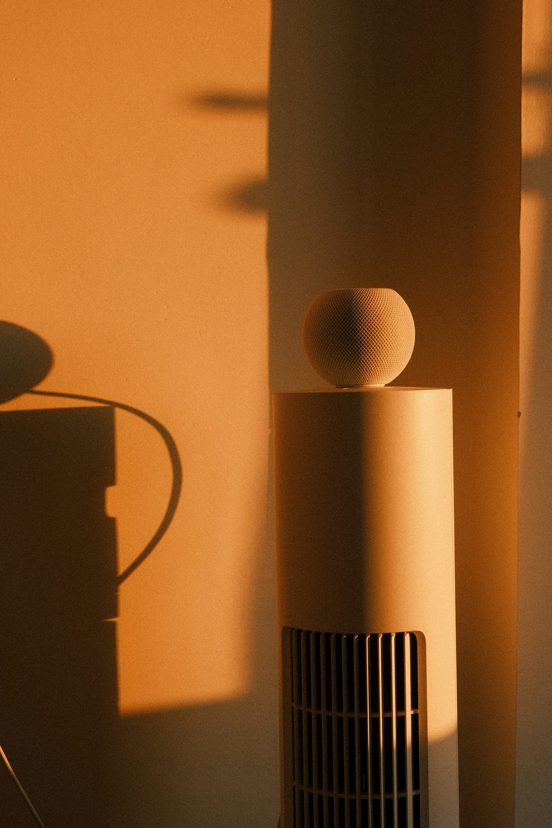 a white object sitting on top of a table next to a wall